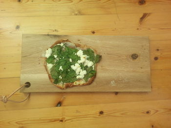 High angle view of tarte flambee on cutting board at home