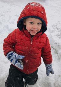 Portrait of smiling girl standing in snow