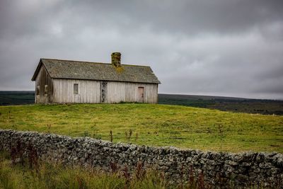 Built structure on field against sky