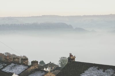 High angle view of houses during foggy weather
