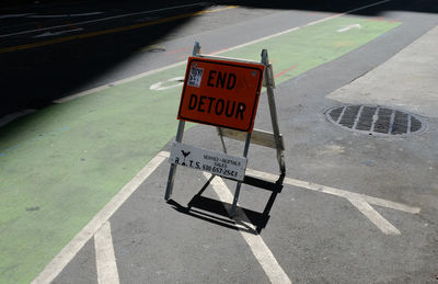 High angle view of road sign on street