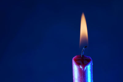Close-up of illuminated lamp against black background