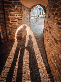 Shadow of man walking on footpath