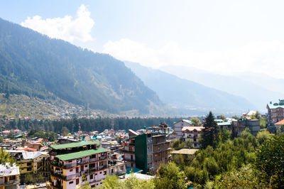 High angle view of townscape and mountains against sky