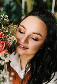 Close-up portrait of a smiling young woman