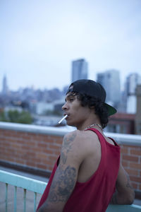 Young man hanging out on a building rooftop