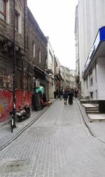People on street in city against clear sky