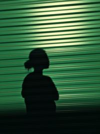 Silhouette man standing on umbrella