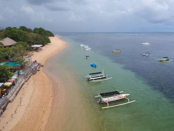 High angle view of boats moored on sea against sky