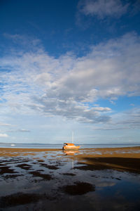 Scenic view of beach against sky during sunset