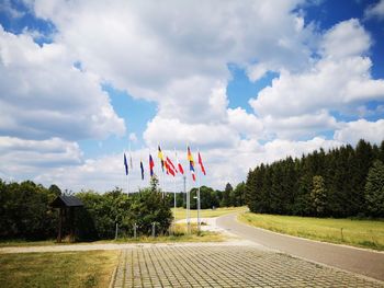 Scenic view of flag amidst trees against sky