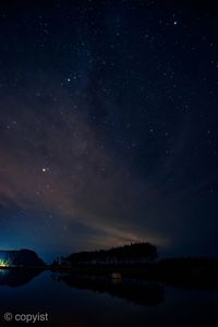 Scenic view of lake against star field at night