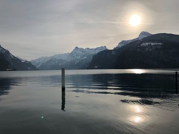 Scenic view of lake and mountains against sky