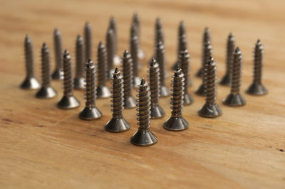 Close-up of screws on wooden table