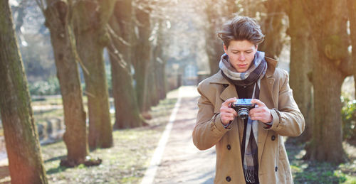 Young man holding camera