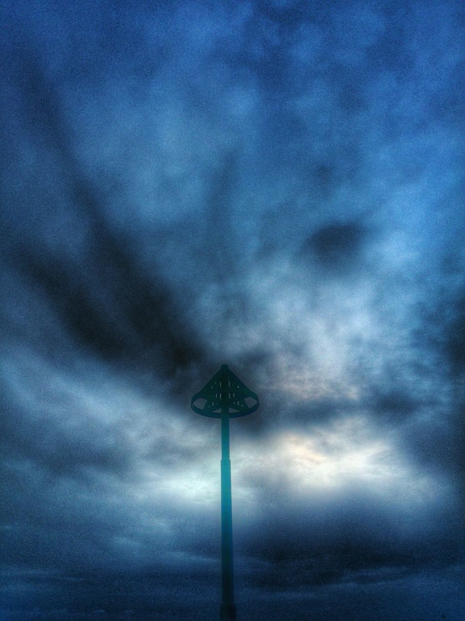 low angle view, sky, cloud - sky, cloudy, lighting equipment, weather, street light, communication, cloud, blue, pole, dusk, overcast, outdoors, guidance, nature, communications tower, no people, storm cloud, technology