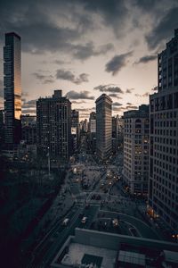 High angle view of city lit up at sunset