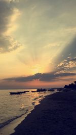 Scenic view of beach against sky during sunset