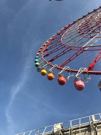 Low angle view of ferris wheel against sky