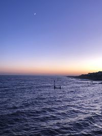 Scenic view of sea against clear sky during sunset