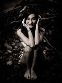 Portraiture shot of a beautiful asian female model in bikini at a river