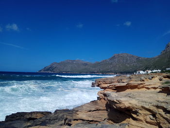 Scenic view of sea against clear blue sky