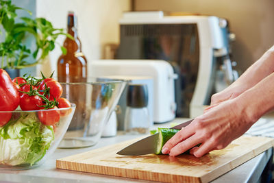 Woman prepare salad with green vegetable