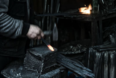 Midsection of man working on barbecue grill