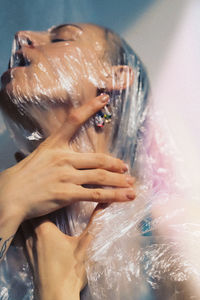 Woman covering face with plastic