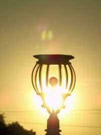 Sun shining through clouds at sunset