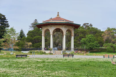 Gazebo in park against building