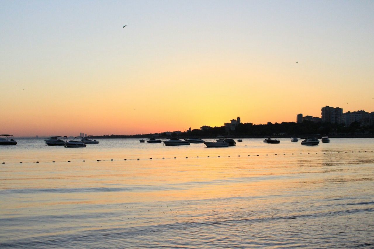 SCENIC VIEW OF SEA AGAINST CLEAR SKY AT SUNSET