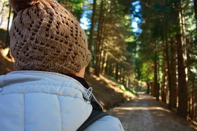 Rear view of woman wearing hat against trees