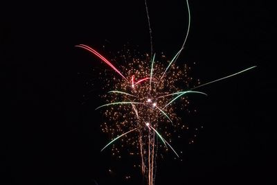 Low angle view of firework display at night