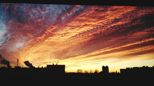 Silhouette of building against dramatic sky