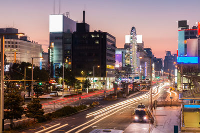 Light trails on city street and buildings at night