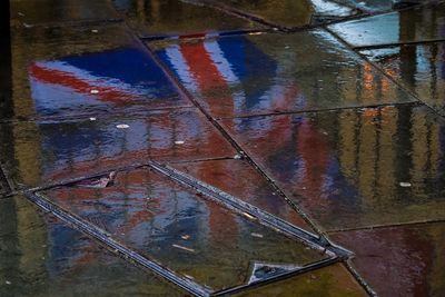 High angle view of rusty reflection in puddle