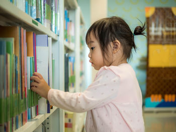 Side view of a girl looking at book