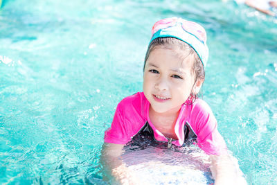 Portrait of happy boy swimming in pool