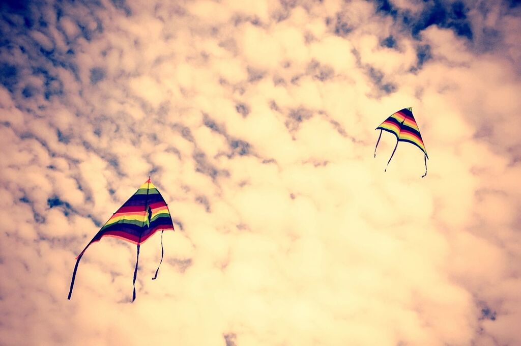 flying, sky, low angle view, flag, identity, mid-air, patriotism, cloud - sky, wind, multi colored, kite - toy, national flag, parachute, american flag, kite, cloud, striped, freedom, hot air balloon, cloudy