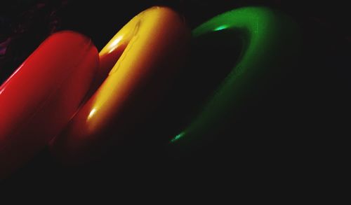 Close-up of illuminated lamp over black background