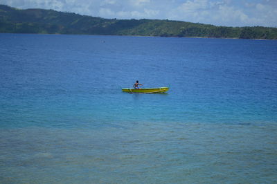 Man rowing boat in lake