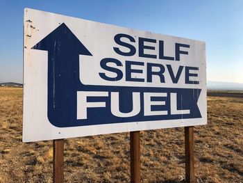 Close-up of road sign on field