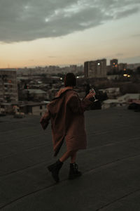 Rear view of woman walking on street