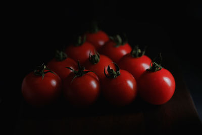 Close-up of cherry tomatoes on table against black background