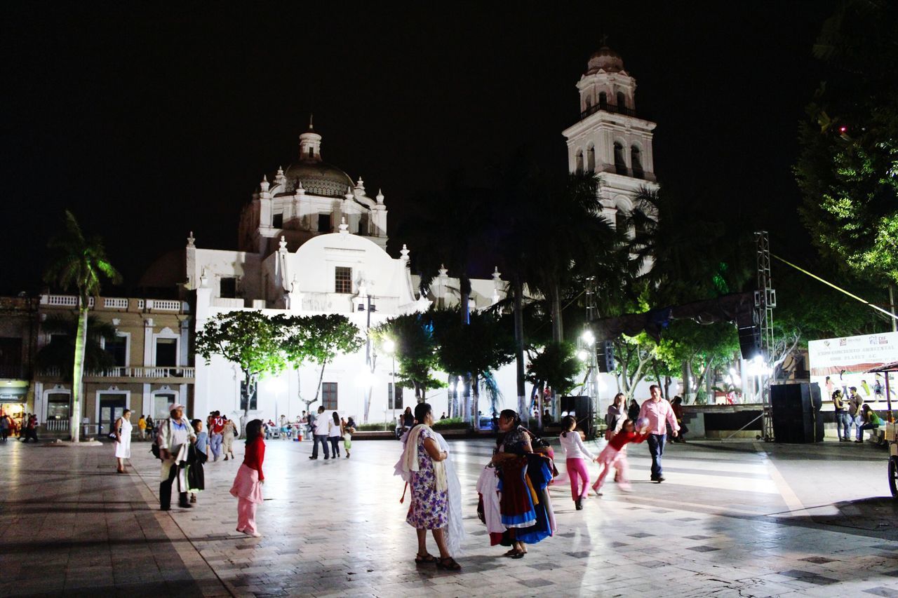 GROUP OF PEOPLE IN TEMPLE OUTSIDE BUILDING