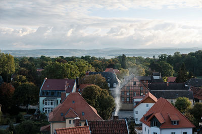 High angle view of houses and buildings against sky