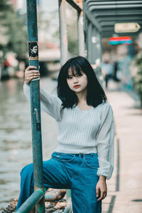 Young woman standing against the wall