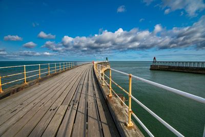 Pier over sea against sky