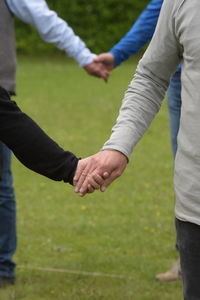 Midsection of man holding hands